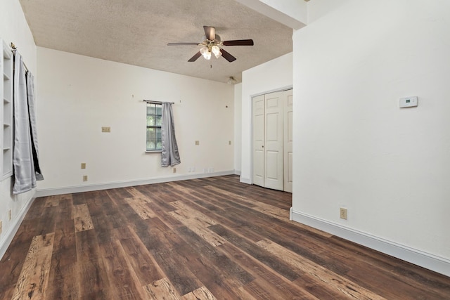 134 Sherwood Trl, Silsbee, TX 77656 - spare room with ceiling fan, dark wood finished floors, a textured ceiling, and baseboards