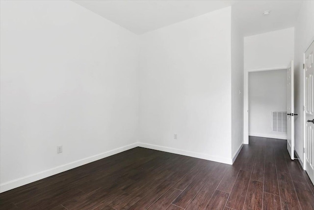 unfurnished room with dark hardwood / wood-style floors