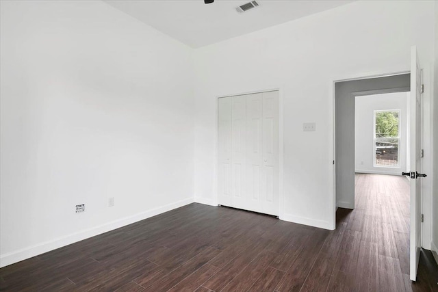 empty room with dark hardwood / wood-style flooring