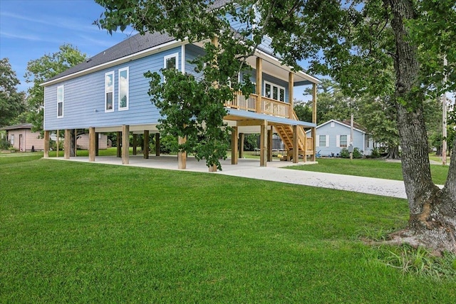 back of property with a carport and a lawn