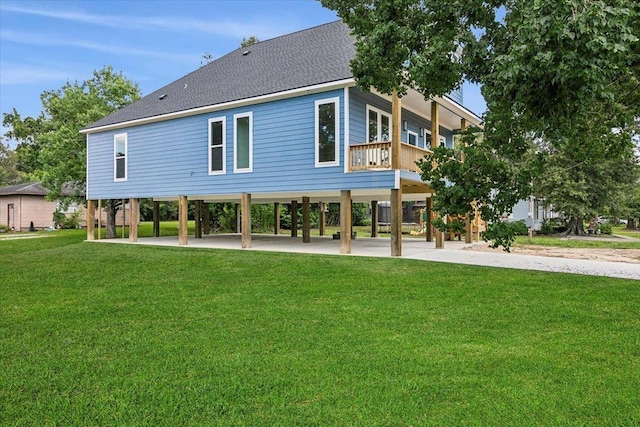 back of property with a yard and a carport