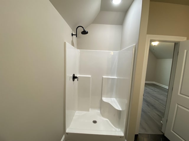 bathroom with a shower and lofted ceiling