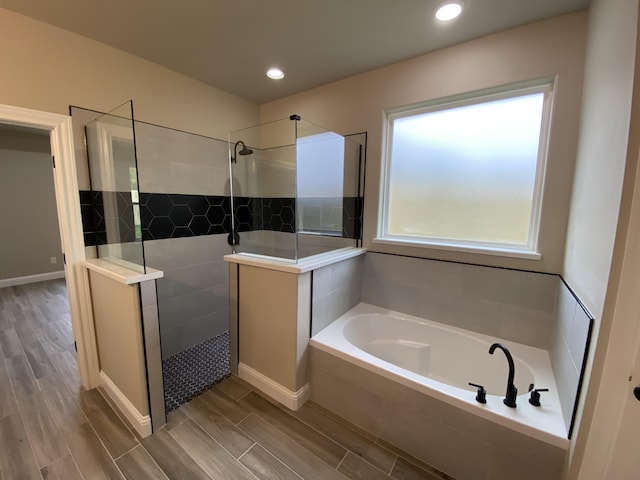 bathroom featuring shower with separate bathtub