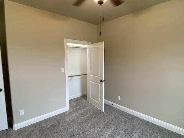 unfurnished bedroom with ceiling fan, a closet, and carpet floors