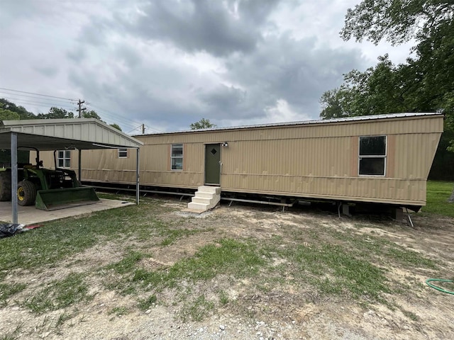 back of house with a carport