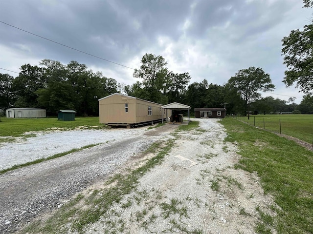 view of front of house featuring an outdoor structure and a carport