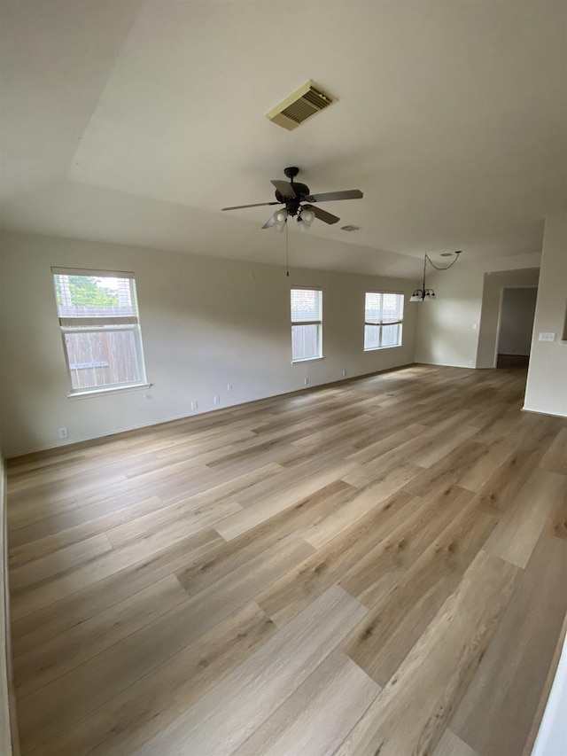 spare room with a healthy amount of sunlight, light wood-type flooring, and visible vents