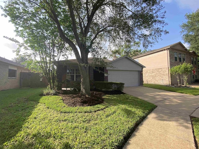 view of front facade featuring brick siding, a garage, driveway, and a front yard
