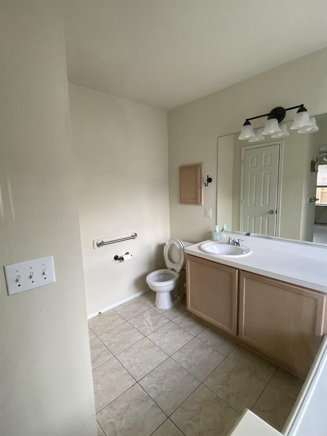 half bath with toilet, tile patterned flooring, and vanity