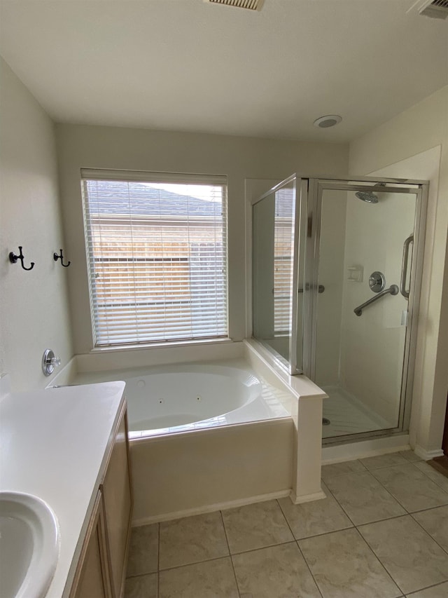 bathroom with a jetted tub, vanity, tile patterned flooring, and a shower stall