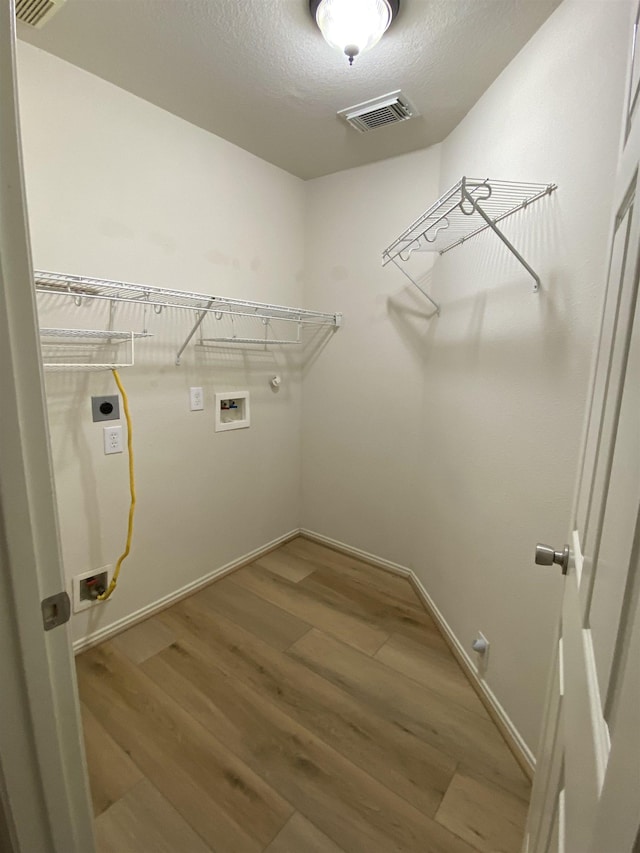 washroom with washer hookup, laundry area, gas dryer hookup, electric dryer hookup, and visible vents