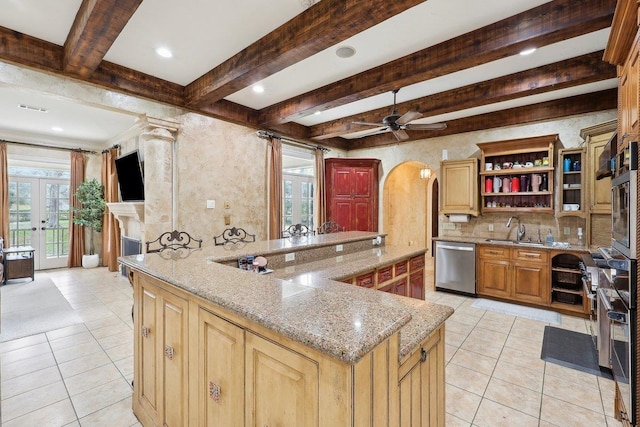 kitchen featuring sink, light tile patterned floors, light stone countertops, and appliances with stainless steel finishes