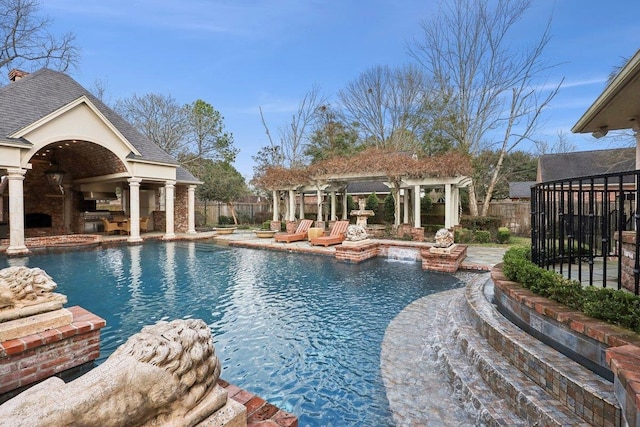 view of pool with a gazebo, pool water feature, an outdoor structure, and a fireplace