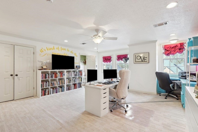 carpeted office with ceiling fan, plenty of natural light, a textured ceiling, and ornamental molding