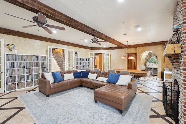 living room with pool table, a fireplace, and beamed ceiling