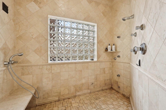 bathroom with a tile shower