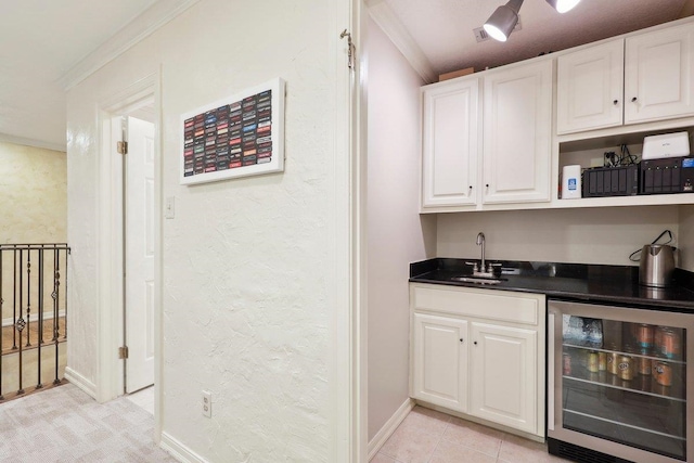 bar with white cabinets, light tile patterned flooring, sink, and wine cooler