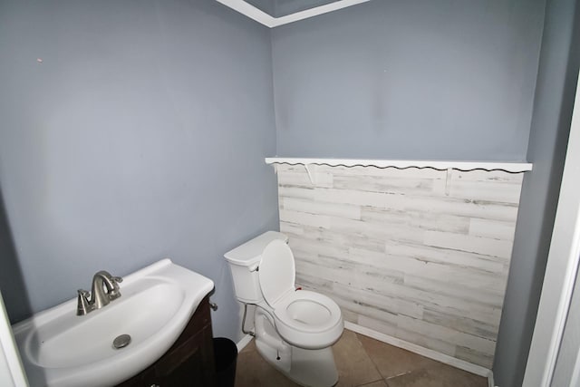 half bathroom with tile patterned floors, a sink, and toilet