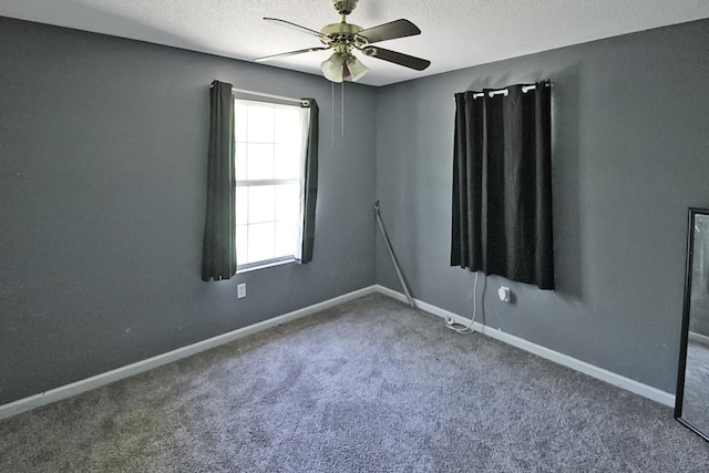 unfurnished room featuring a textured ceiling, ceiling fan, baseboards, and carpet floors