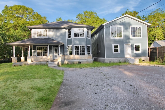 back of property featuring crawl space, covered porch, a lawn, entry steps, and fence