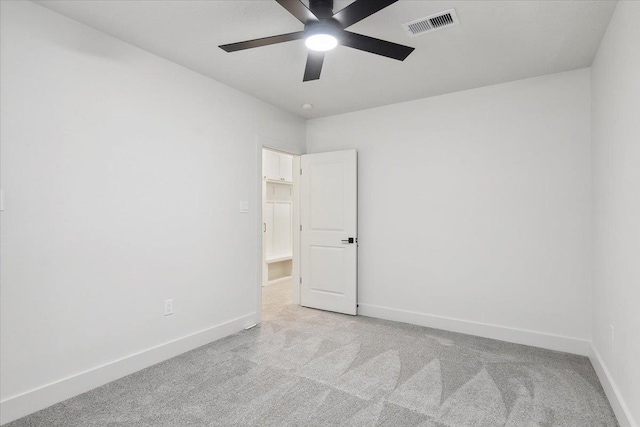 unfurnished room with ceiling fan and light colored carpet