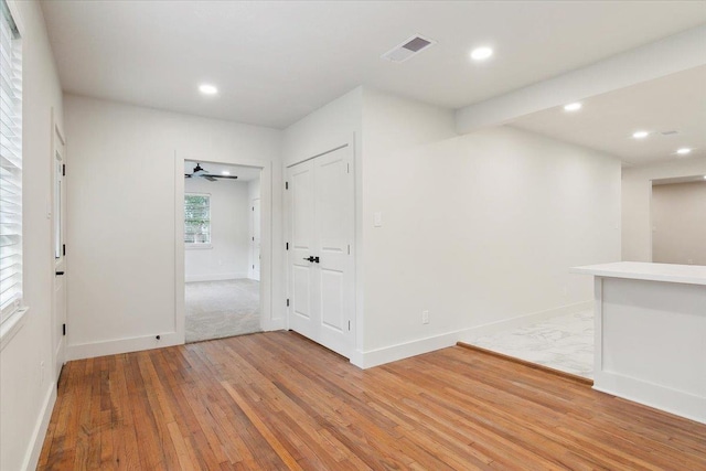 spare room with ceiling fan and wood-type flooring