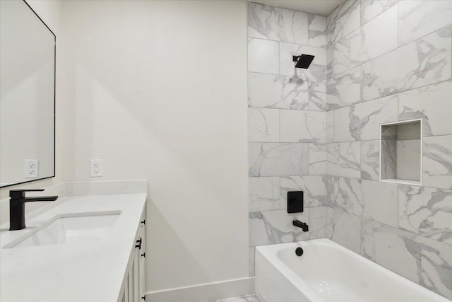 bathroom featuring vanity and tiled shower / bath