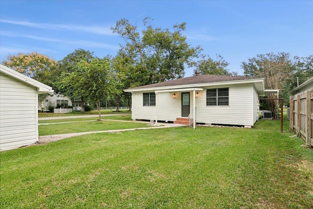 view of front of home featuring a front yard and central AC