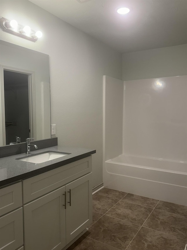 bathroom featuring bathtub / shower combination and vanity