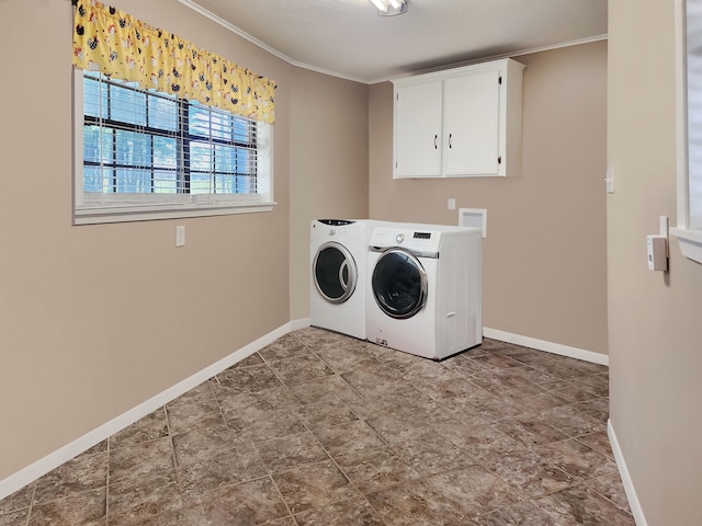 clothes washing area with crown molding, baseboards, cabinet space, and washing machine and dryer