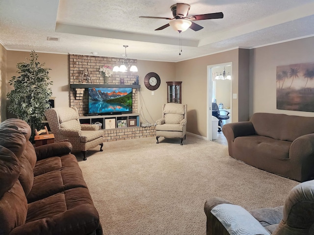 living room featuring carpet floors, a textured ceiling, ceiling fan with notable chandelier, and a raised ceiling