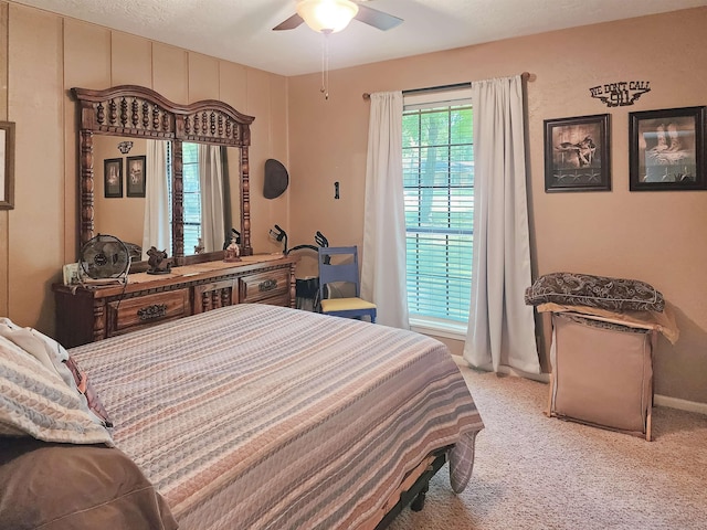 carpeted bedroom with baseboards and a ceiling fan