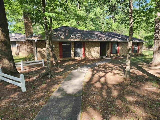 ranch-style house with brick siding and fence