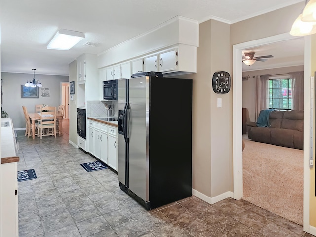 kitchen featuring white cabinets, baseboards, black appliances, ceiling fan with notable chandelier, and decorative backsplash