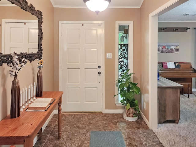 foyer entrance with baseboards, ornamental molding, and visible vents