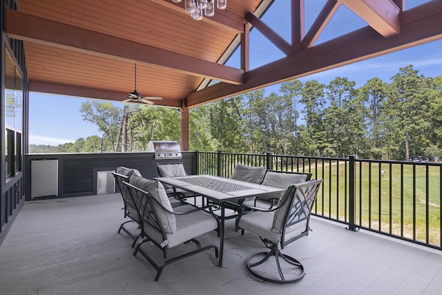 view of patio featuring outdoor dining space, a grill, a wooden deck, and ceiling fan