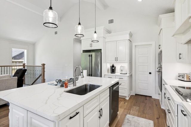 kitchen with visible vents, a sink, wood finished floors, appliances with stainless steel finishes, and white cabinets