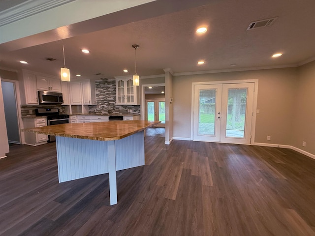 2370 Central Dr, Beaumont, TX 77706 - kitchen featuring stainless steel appliances, french doors, white cabinets, ornamental molding, and backsplash