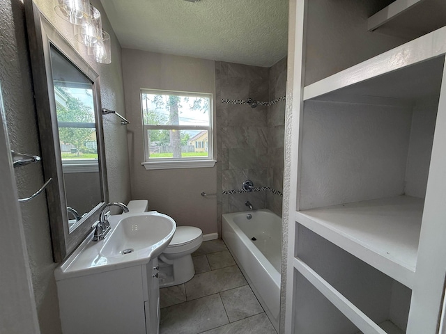 2370 Central Dr, Beaumont, TX 77706 - bathroom featuring toilet, vanity, a textured ceiling, tile patterned flooring, and bathtub / shower combination