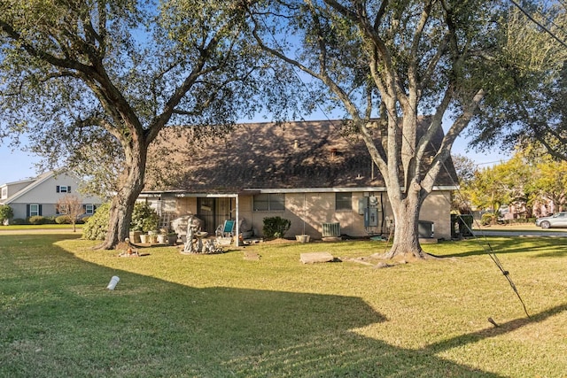 back of property with a lawn