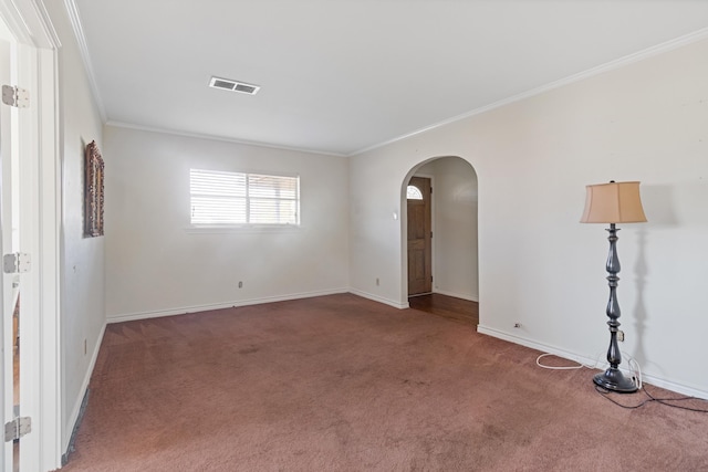 unfurnished room with crown molding and carpet