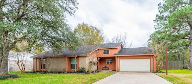 view of front of property with a garage and a front lawn