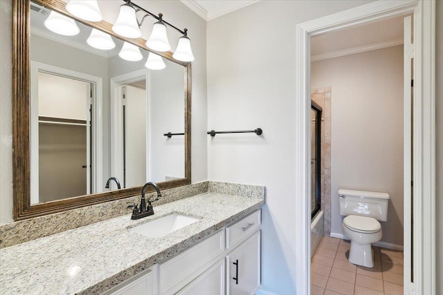 full bathroom featuring tile patterned flooring, enclosed tub / shower combo, toilet, vanity, and ornamental molding