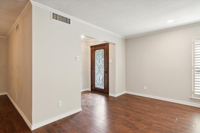 entrance foyer featuring a textured ceiling, a healthy amount of sunlight, dark hardwood / wood-style floors, and ornamental molding