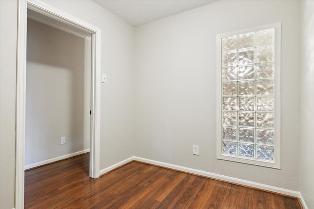 unfurnished room with dark wood-type flooring