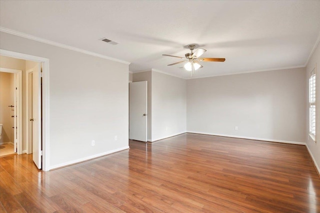 empty room with hardwood / wood-style flooring, ceiling fan, and ornamental molding