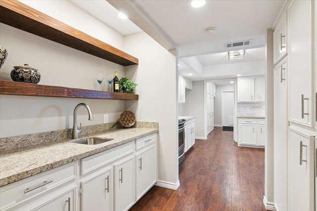 kitchen featuring light stone counters, dark wood-type flooring, sink, white cabinetry, and stainless steel electric range