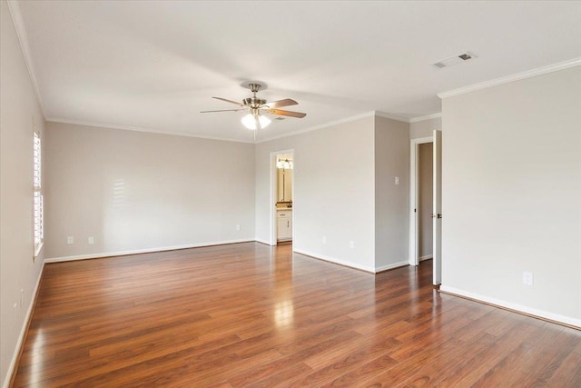 spare room featuring crown molding, ceiling fan, and dark hardwood / wood-style floors