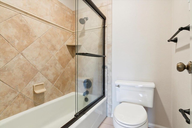 bathroom with toilet and shower / bath combination with glass door