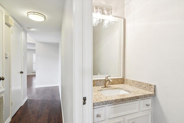 bathroom with hardwood / wood-style floors and vanity